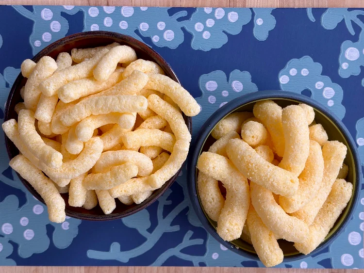 An overhead shot of Cheetos Simply Puffs and Cheetos Simply NKD Puffs