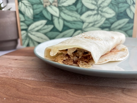 An side view of the finished form of a loaded crunchwrap