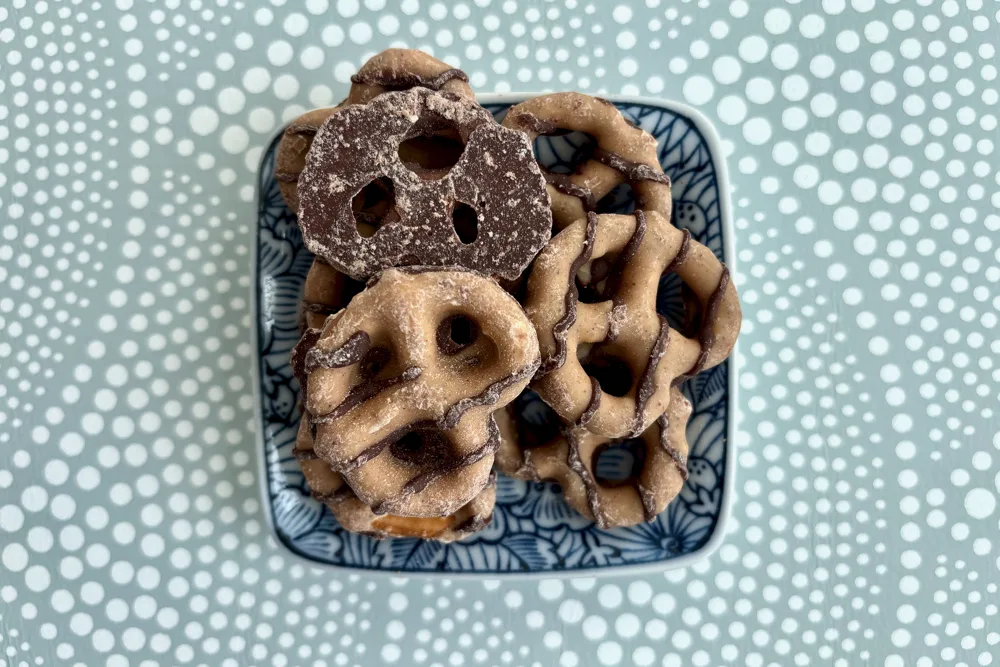 A bowl of Reese's Dipped Pretzels in front of a hypnotic background